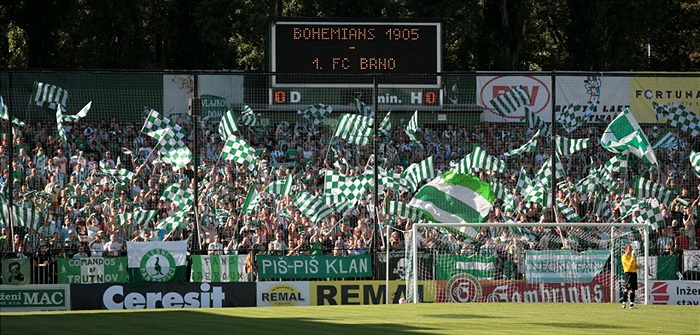 Zaplněný kotel s vlajkami.