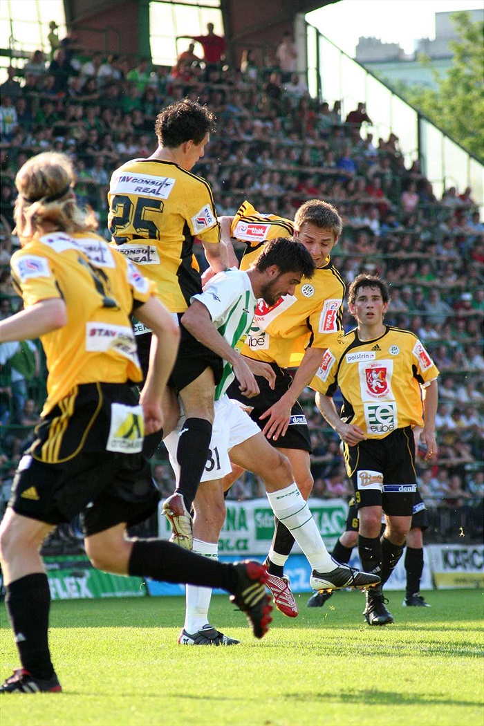 Bálek mezi žlutou hradbou.